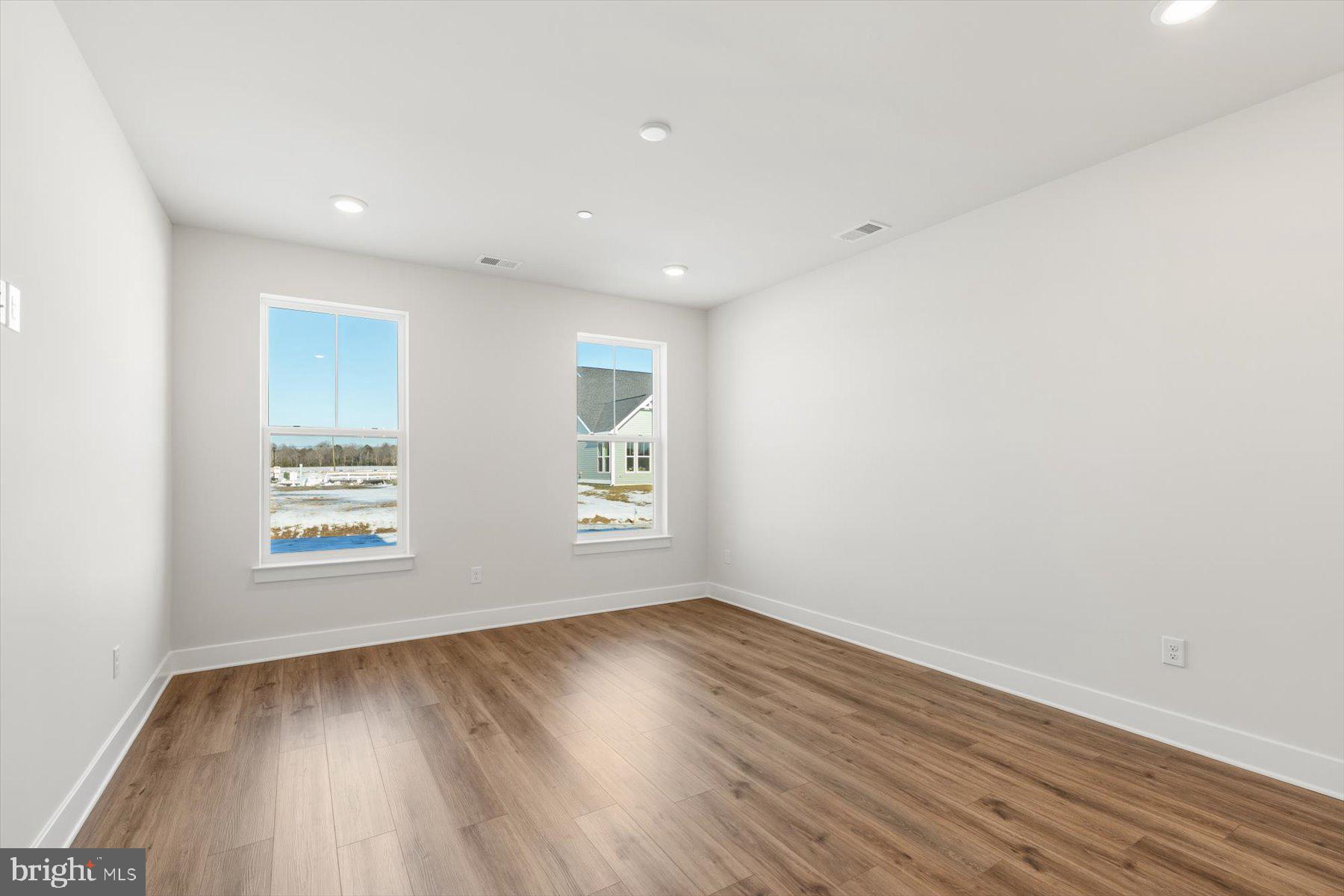 104 Sunbeam Way Milton, DE 19968 - Photo 27 of 56 an empty room with wooden floor and windows