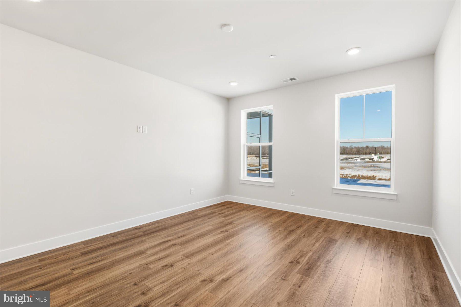 104 Sunbeam Way Milton, DE 19968 - Photo 28 of 56 an empty room with wooden floor and windows