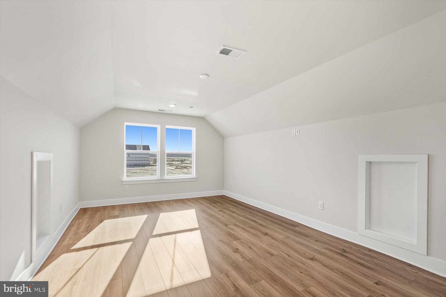 104 Sunbeam Way Milton, DE 19968 - Photo 45 of 56 an empty room with wooden floor and windows