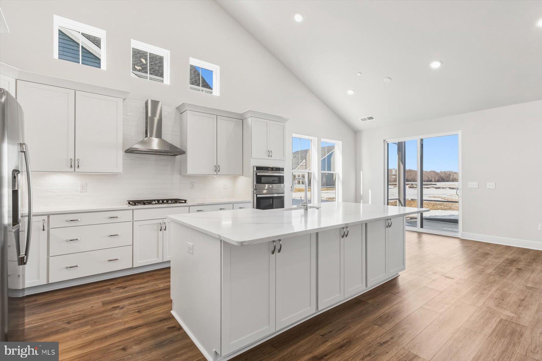 104 Sunbeam Way Milton, DE 19968 - Photo 5 of 56 a kitchen with stainless steel appliances granite countertop a lot of counter space and wooden floors