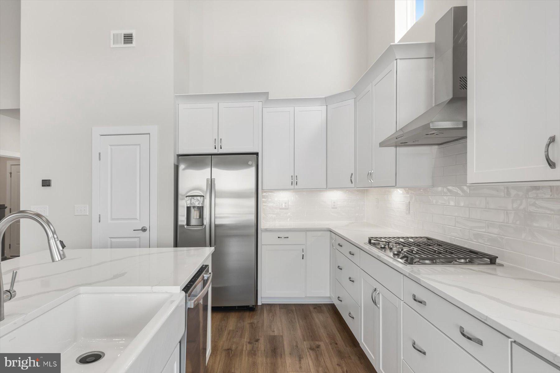 104 Sunbeam Way Milton, DE 19968 - Photo 10 of 56 a kitchen with white cabinets and appliances