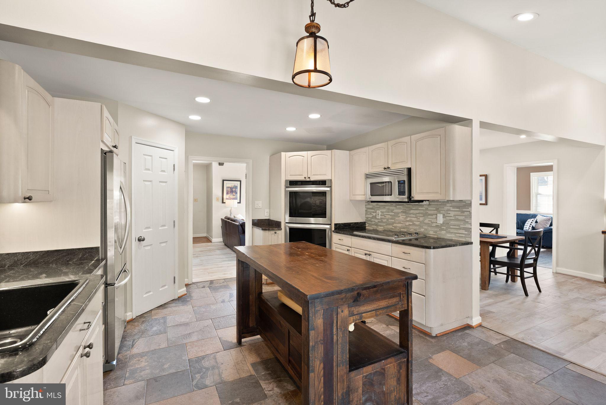 3012 Russell Road Alexandria, VA 22305 - Photo 13 of 56 a large kitchen with a table and chairs in it