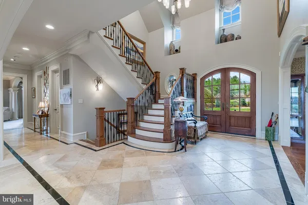 a view of a dining room with furniture a chandelier and wooden floor