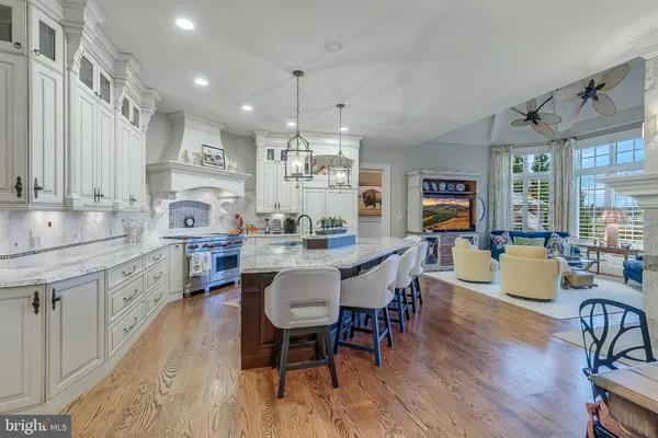a view of a hallway with wooden floor and entryway