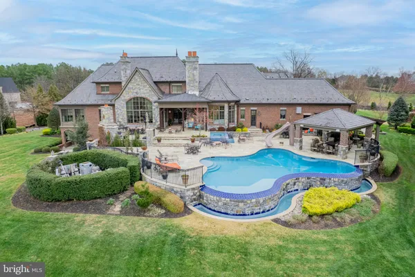 a patio with glass top table and chairs