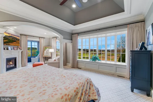 a living room with patio furniture and a floor to ceiling window