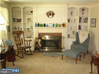 27 Harvard Road Audubon, NJ 08106 - Photo 2 of 12 a living room with furniture and a fireplace
