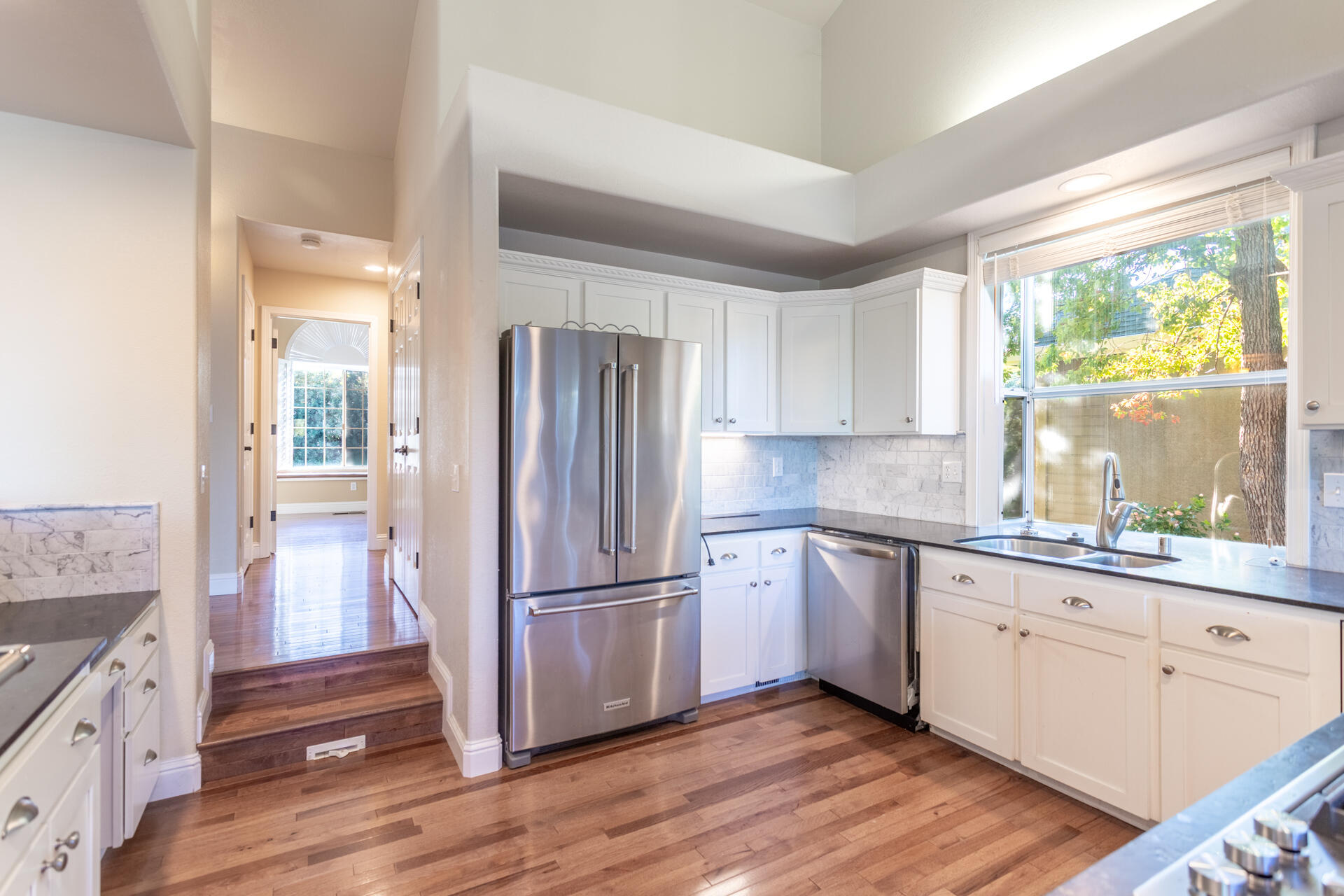 3126 Riesling Path Redding, CA 96001 - Photo 7 of 32 a kitchen with a refrigerator wooden floor and window