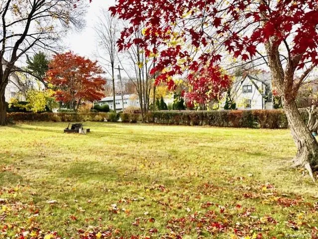 a swimming pool with outdoor seating and yard