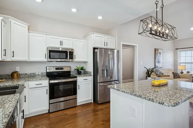 a kitchen with a sink stainless steel appliances and cabinets