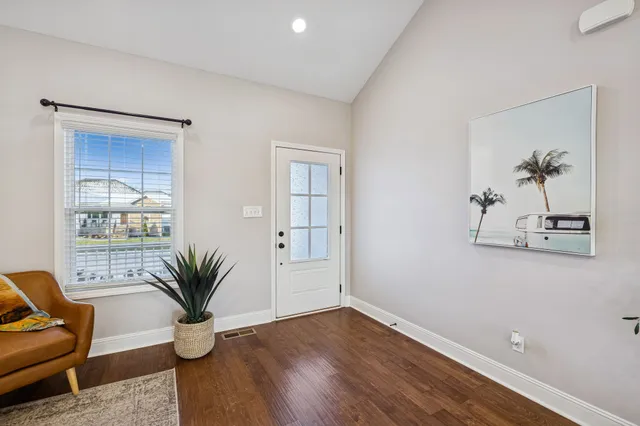 a view of a room with wooden floor and windows