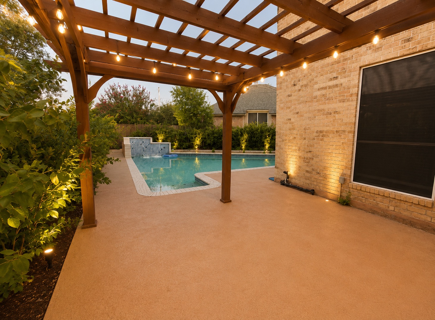 1610 Juniper Ridge Loop Cedar Park, TX 78613 - Photo 27 of 28 A spacious concrete patio under a wooden pergola overlooks a sparkling backyard swimming pool.