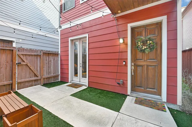 a view of a house with a door and wooden walls