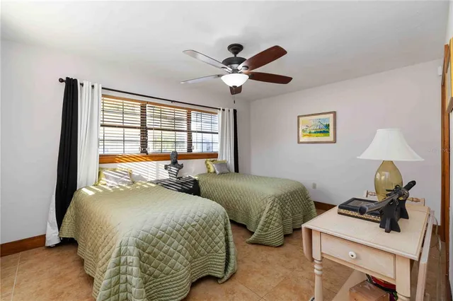 a bedroom with two beds and a window