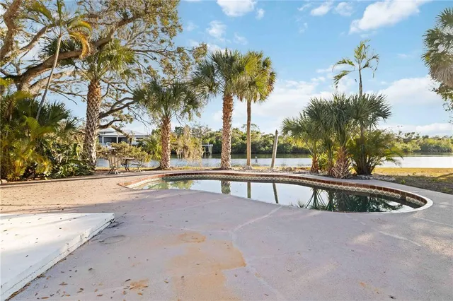 a view of swimming pool with outdoor seating and trees
