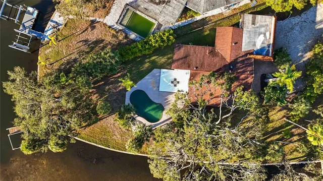 an aerial view of a house with yard swimming pool and outdoor seating