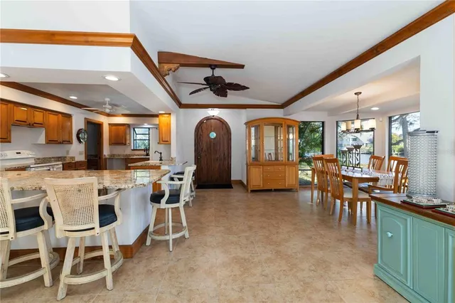 a view of a dining room with furniture and a kitchen
