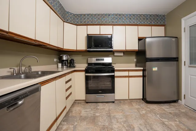 a kitchen with a sink and a refrigerator