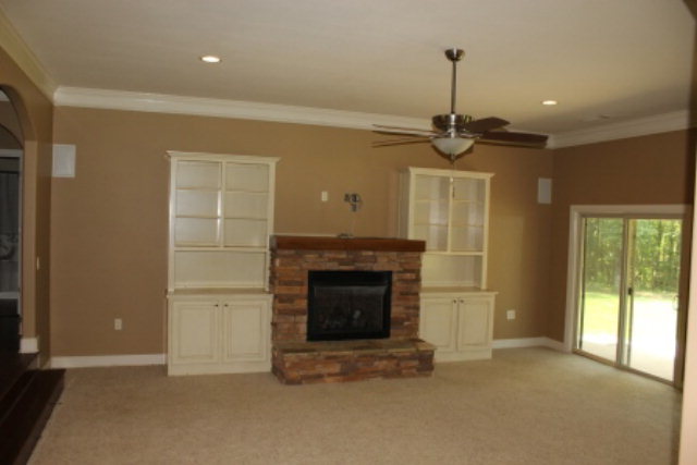 163 Gregory Road Forsyth, GA 31029 - Photo 2 of 20 a view of an empty room with a fireplace and a window