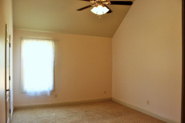 163 Gregory Road Forsyth, GA 31029 - Photo 14 of 20 an empty room with a chandelier fan