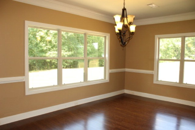 163 Gregory Road Forsyth, GA 31029 - Photo 5 of 20 a view of a livingroom with a large window wooden floor and a chandelier