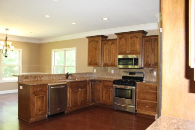 163 Gregory Road Forsyth, GA 31029 - Photo 6 of 20 a kitchen with stainless steel appliances granite countertop a stove a sink and a microwave