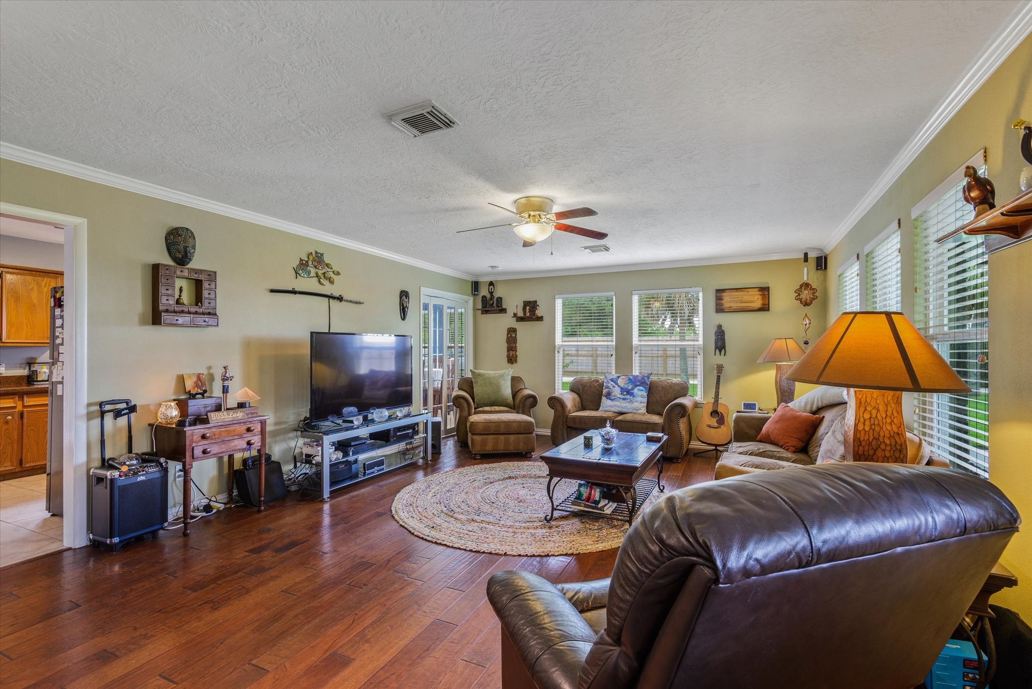 2739 Lawrence Road Kemah, TX 77565 - Photo 14 of 42 a living room with furniture a ceiling fan and a flat screen tv