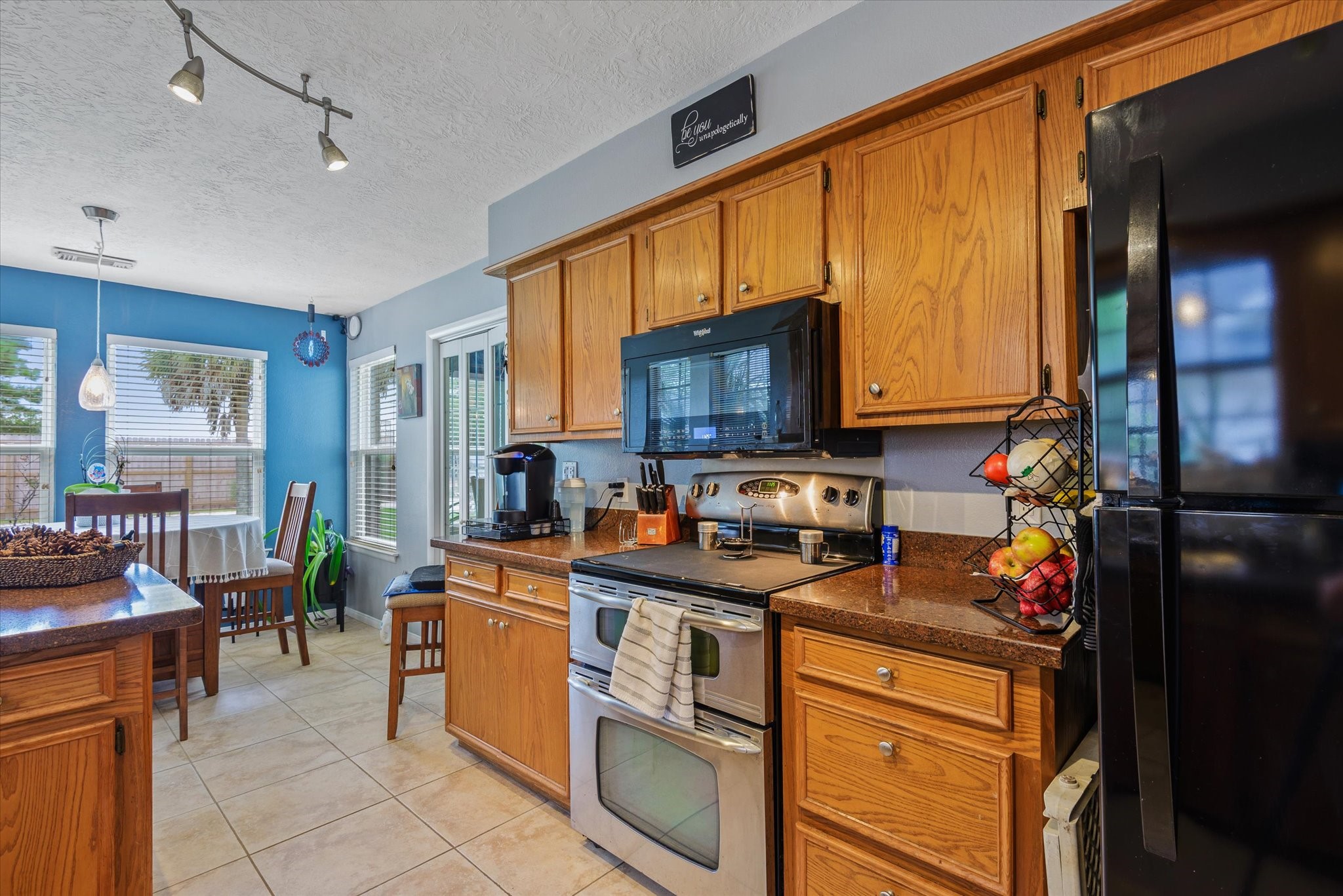 2739 Lawrence Road Kemah, TX 77565 - Photo 20 of 42 a kitchen with stainless steel appliances granite countertop a stove top oven a sink dishwasher a refrigerator and cabinets with wooden floor
