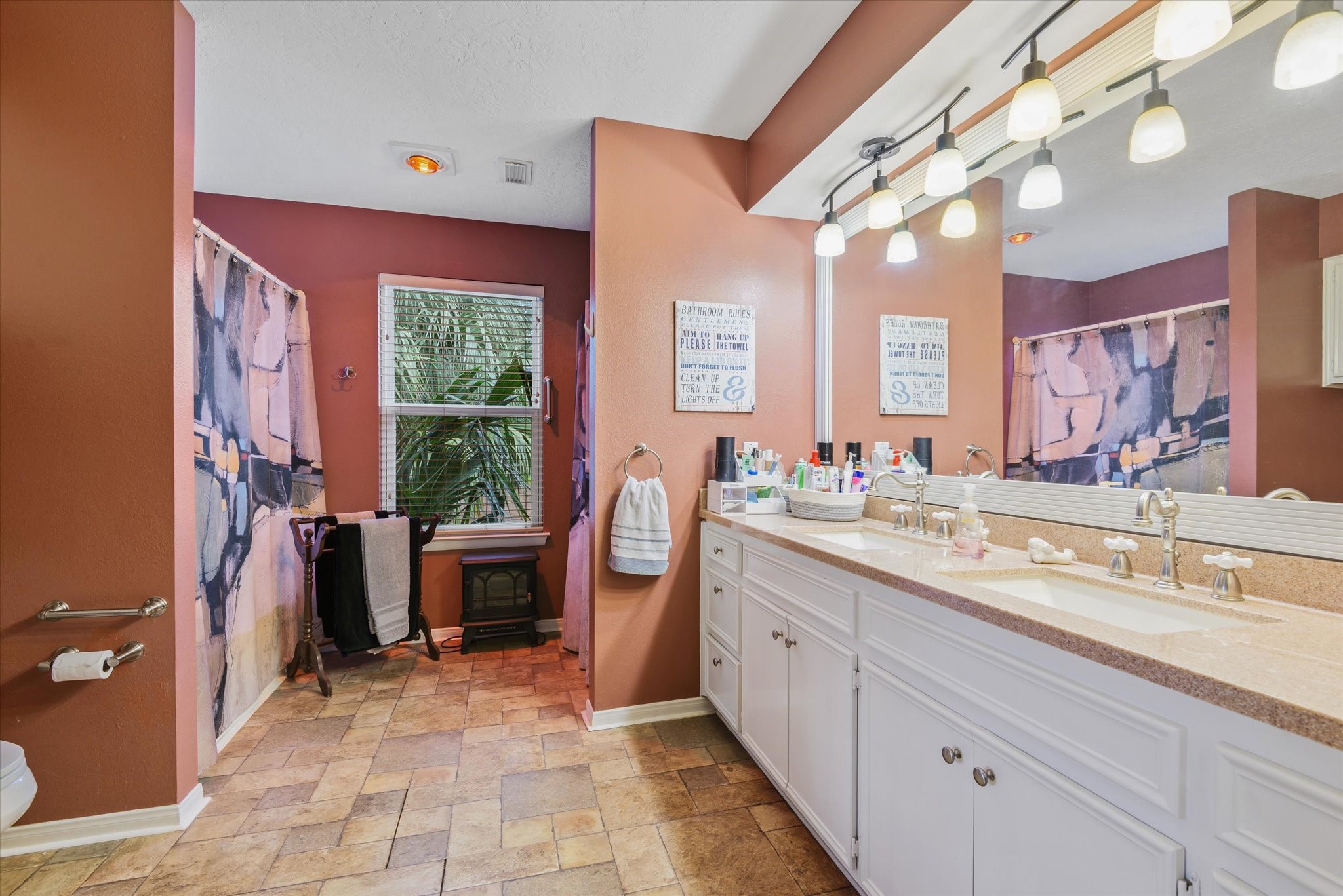 2739 Lawrence Road Kemah, TX 77565 - Photo 26 of 42 a spacious bathroom with a double vanity sink a mirror and a bathtub