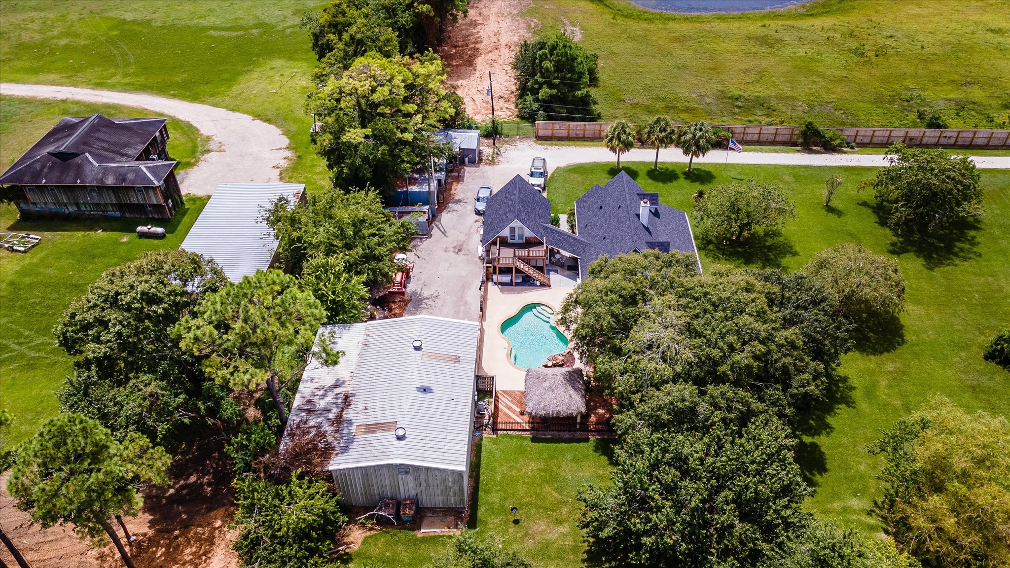 2739 Lawrence Road Kemah, TX 77565 - Photo 4 of 42 an aerial view of a house with a garden and lake view