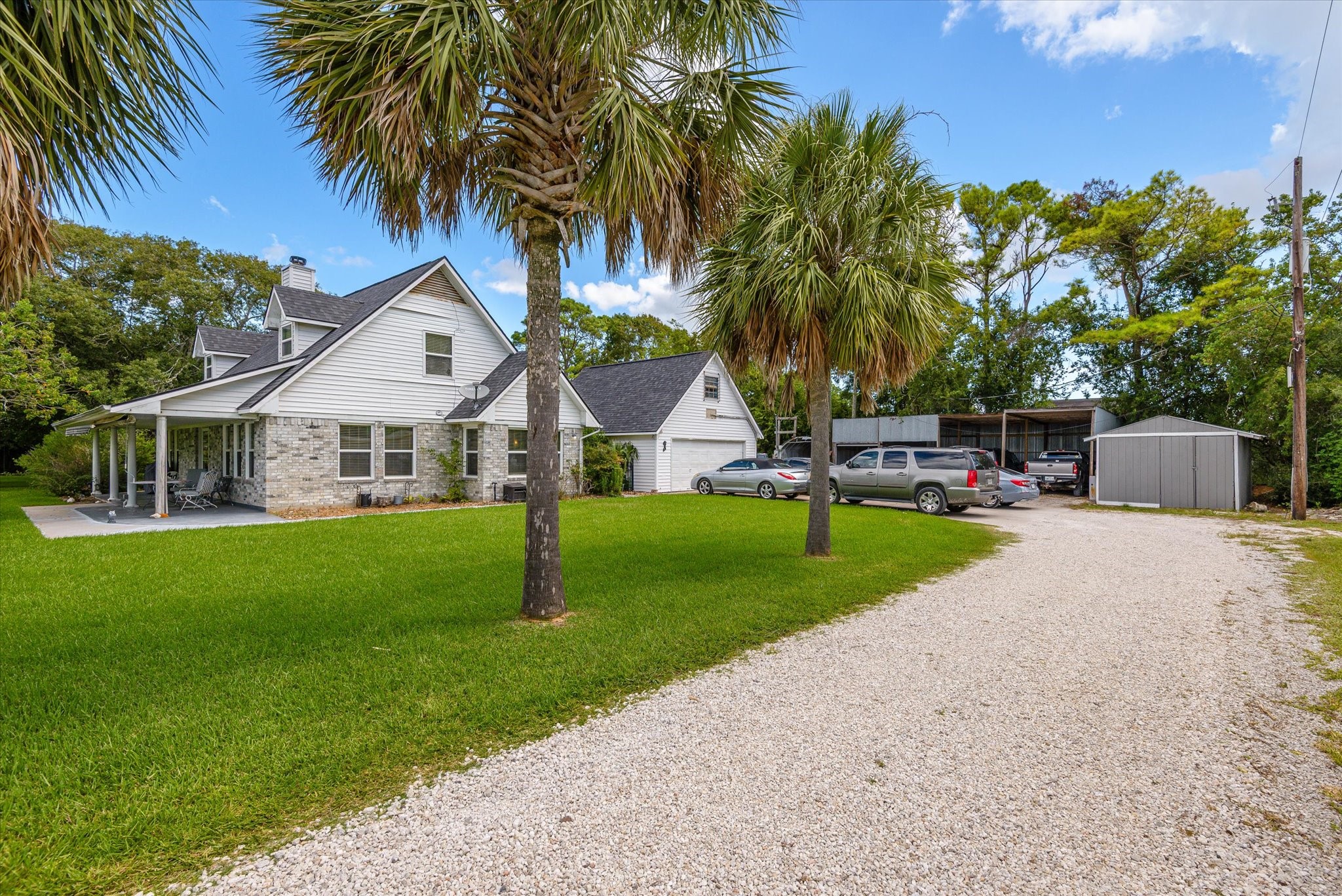 2739 Lawrence Road Kemah, TX 77565 - Photo 7 of 42 a view of a house with a yard and palm trees