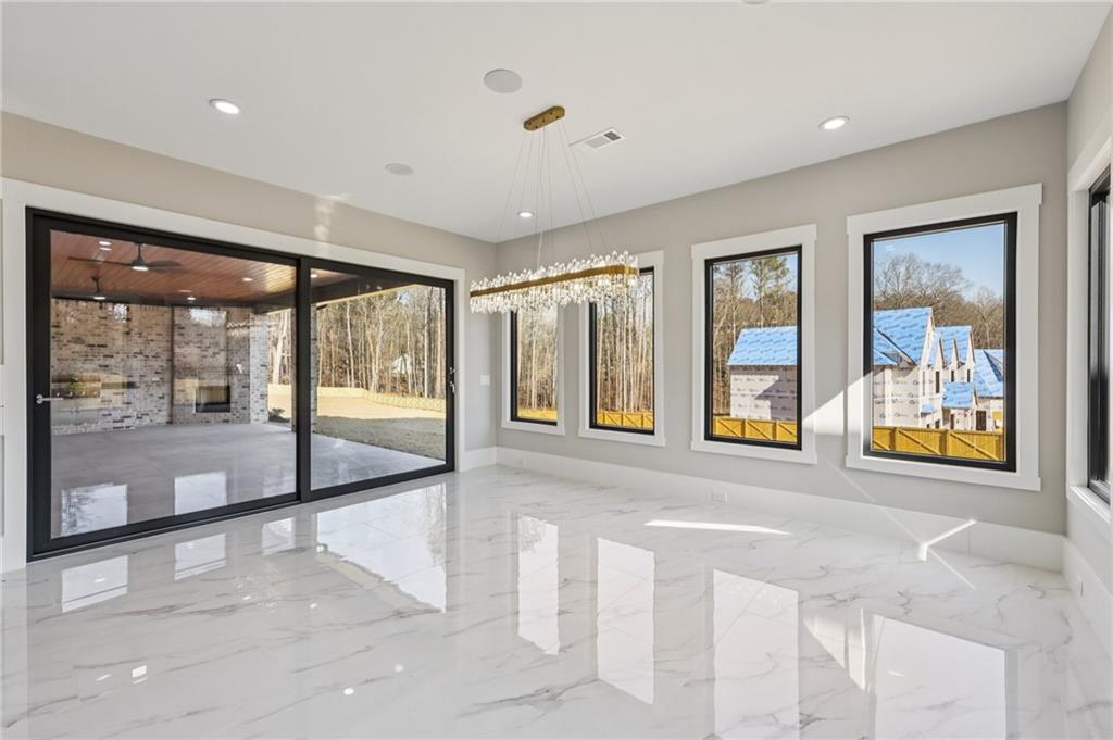 1556 Ewing Chapel Road Dacula, GA 30019 - Photo 12 of 67 a view of an empty room with large windows