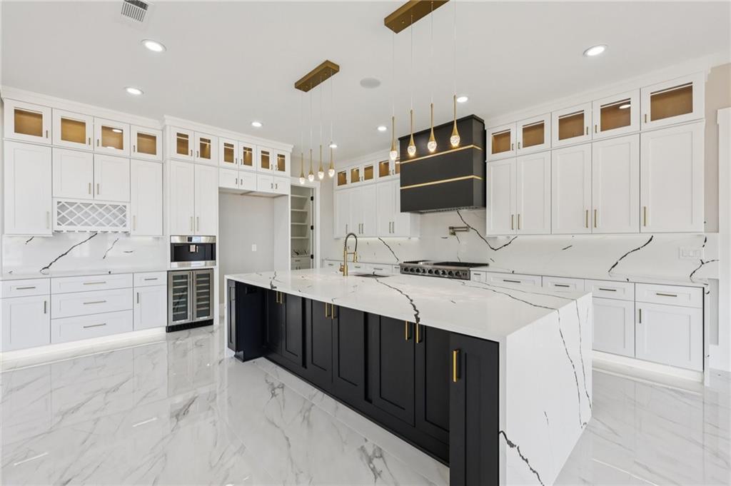1556 Ewing Chapel Road Dacula, GA 30019 - Photo 17 of 67 a kitchen with stainless steel appliances kitchen island granite countertop a sink and cabinets