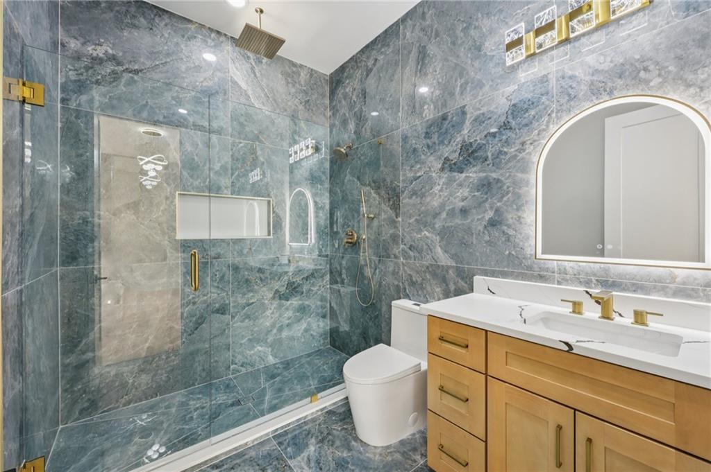 1556 Ewing Chapel Road Dacula, GA 30019 - Photo 27 of 67 a bathroom with a sink a toilet and shower
