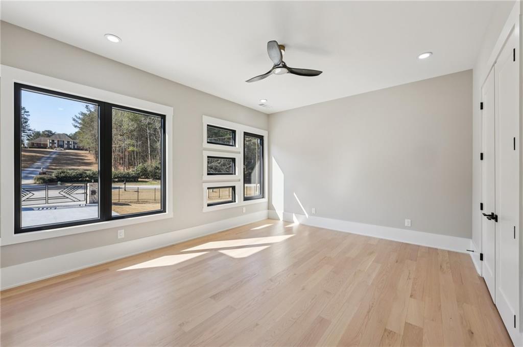 1556 Ewing Chapel Road Dacula, GA 30019 - Photo 32 of 67 a view of an empty room with a window and wooden floor