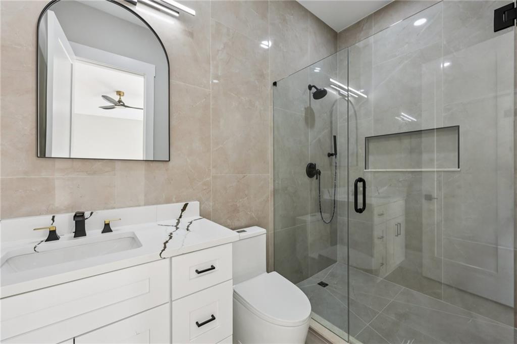 1556 Ewing Chapel Road Dacula, GA 30019 - Photo 34 of 67 a bathroom with a sink a toilet and shower
