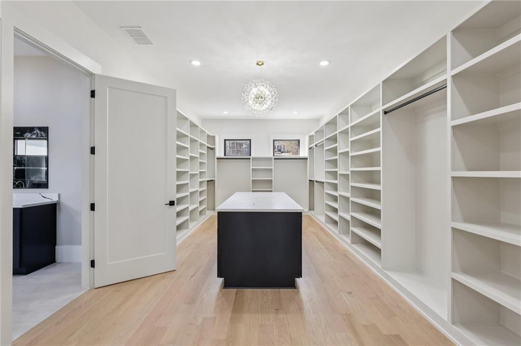 1556 Ewing Chapel Road Dacula, GA 30019 - Photo 42 of 67 a view of a walk in closet and wooden floor