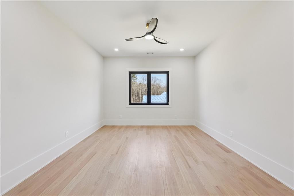 1556 Ewing Chapel Road Dacula, GA 30019 - Photo 44 of 67 a view of a room with wooden floor ceiling fan and window