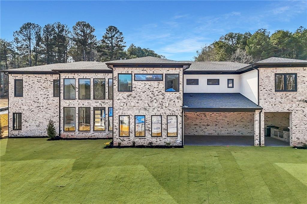 1556 Ewing Chapel Road Dacula, GA 30019 - Photo 63 of 67 a front view of a house with a garden