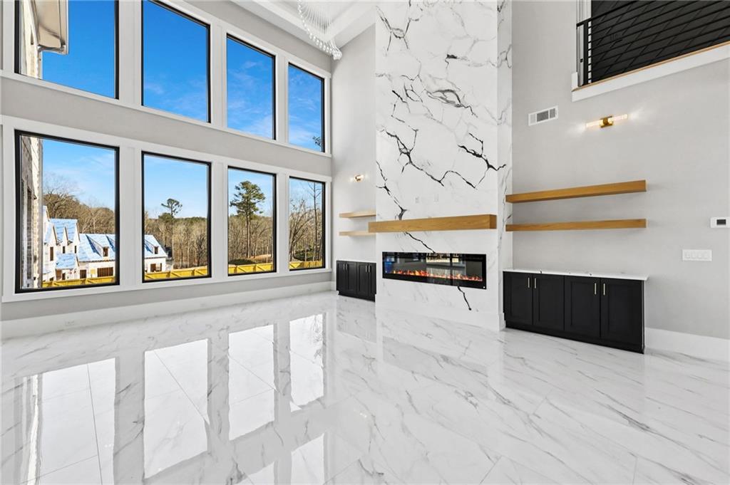 1556 Ewing Chapel Road Dacula, GA 30019 - Photo 7 of 67 a view of an entryway with a floor to ceiling window and a kitchen