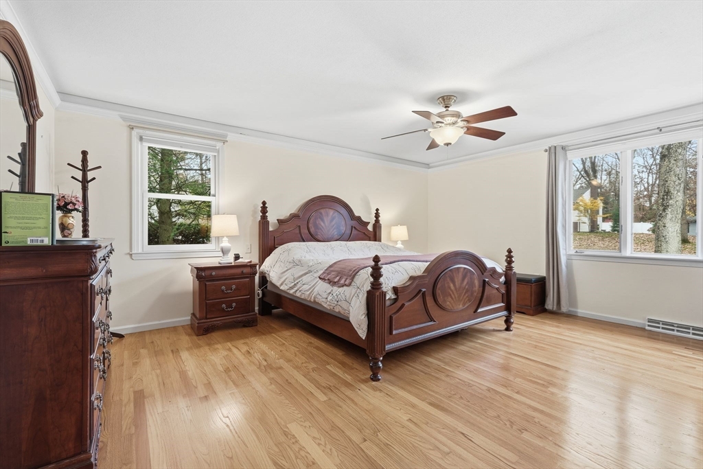 47 Academy Drive Longmeadow, MA 01106 - Photo 27 of 42 a bedroom with a large bed and a chandelier