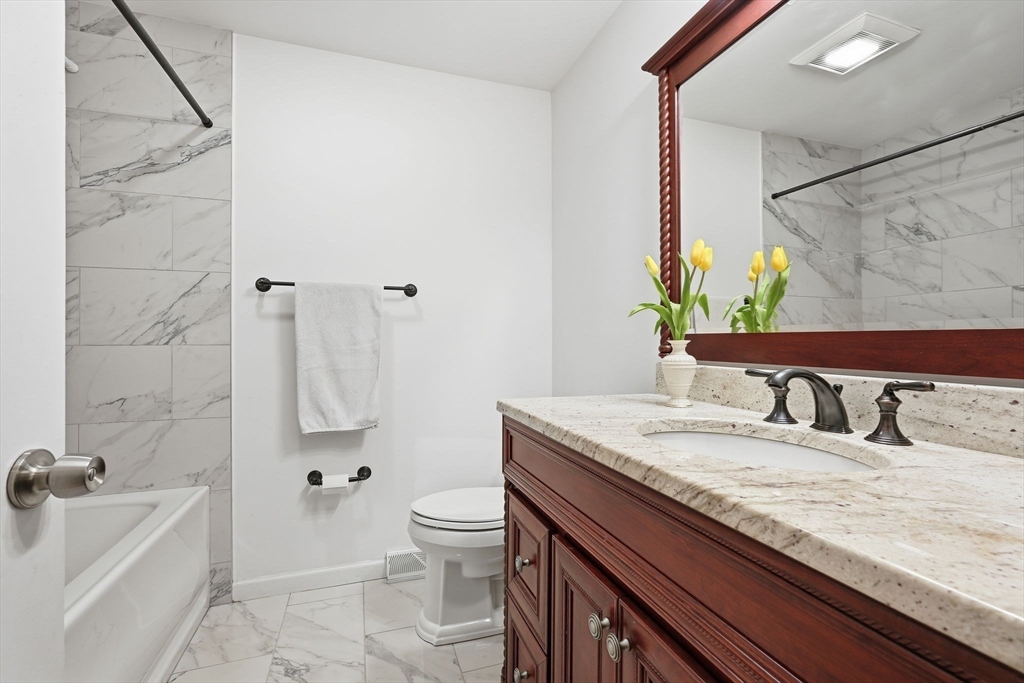 47 Academy Drive Longmeadow, MA 01106 - Photo 34 of 42 a bathroom with a granite countertop sink a toilet and bathtub