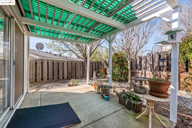 a view of patio with table and chairs and potted plants