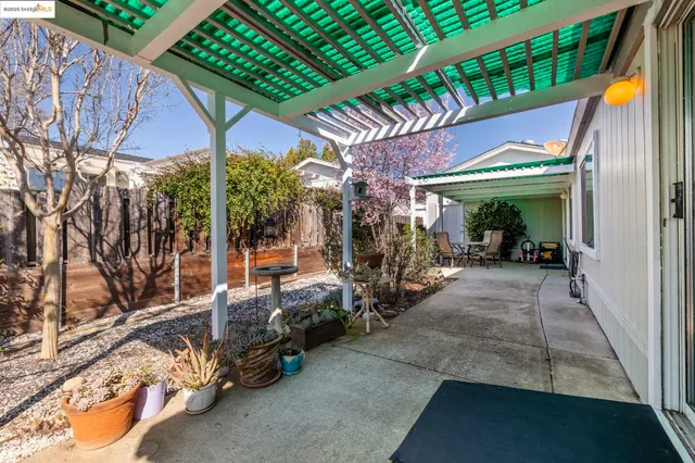 a view of a patio with table and chairs under an umbrella