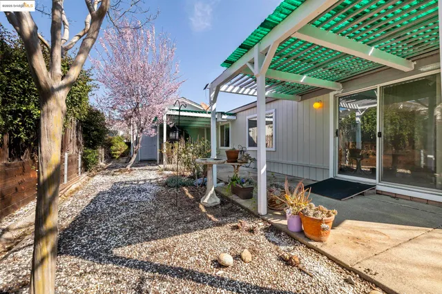 a view of a patio with table and chairs under an umbrella