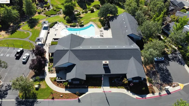 an aerial view of a house with a yard and sitting area