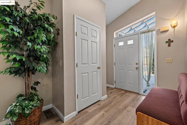 hallway with view of bedroom and wooden floor