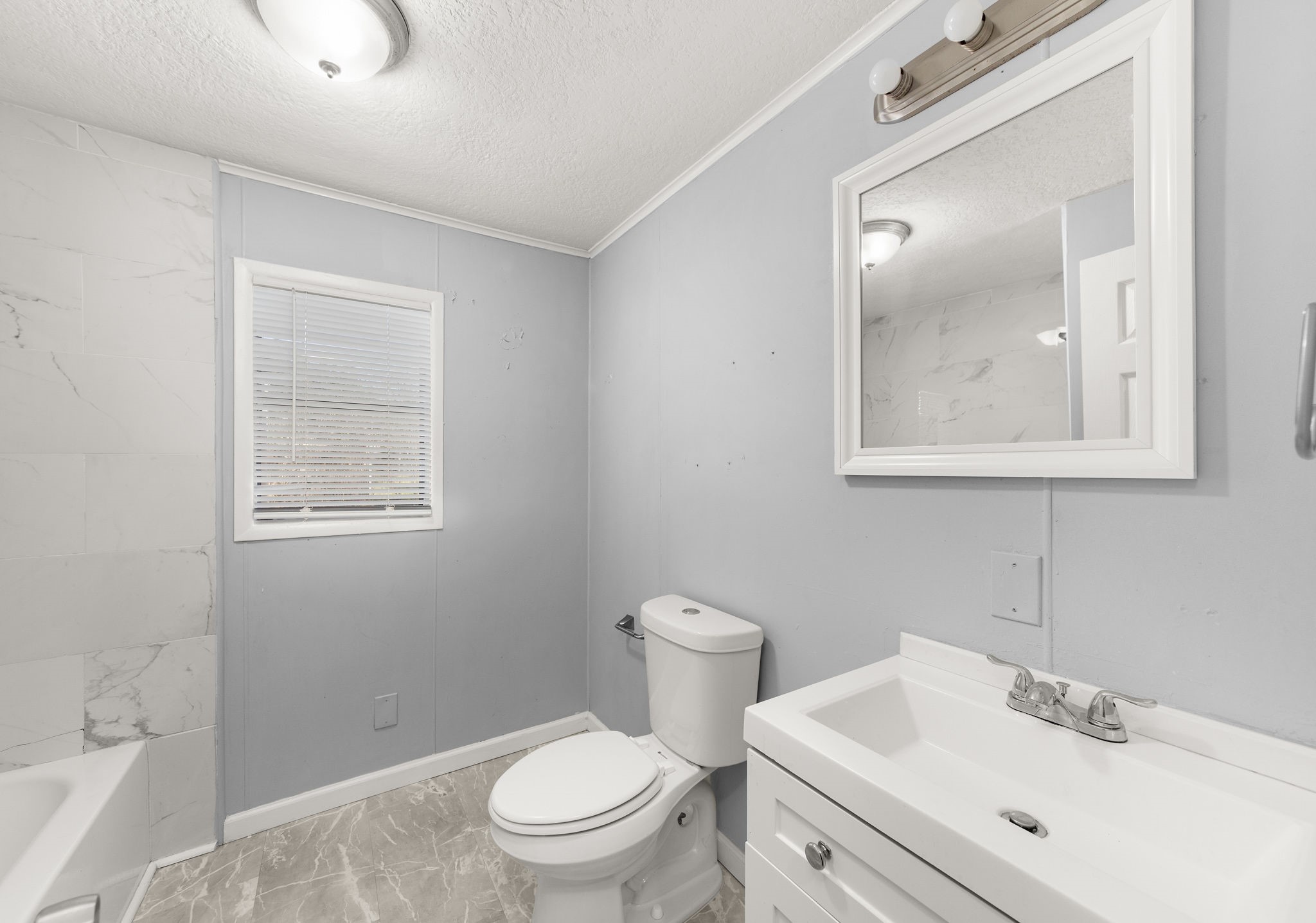 203 South Fig Street Sweeny, TX 77480 - Photo 15 of 20 a bathroom with a toilet sink vanity and mirror