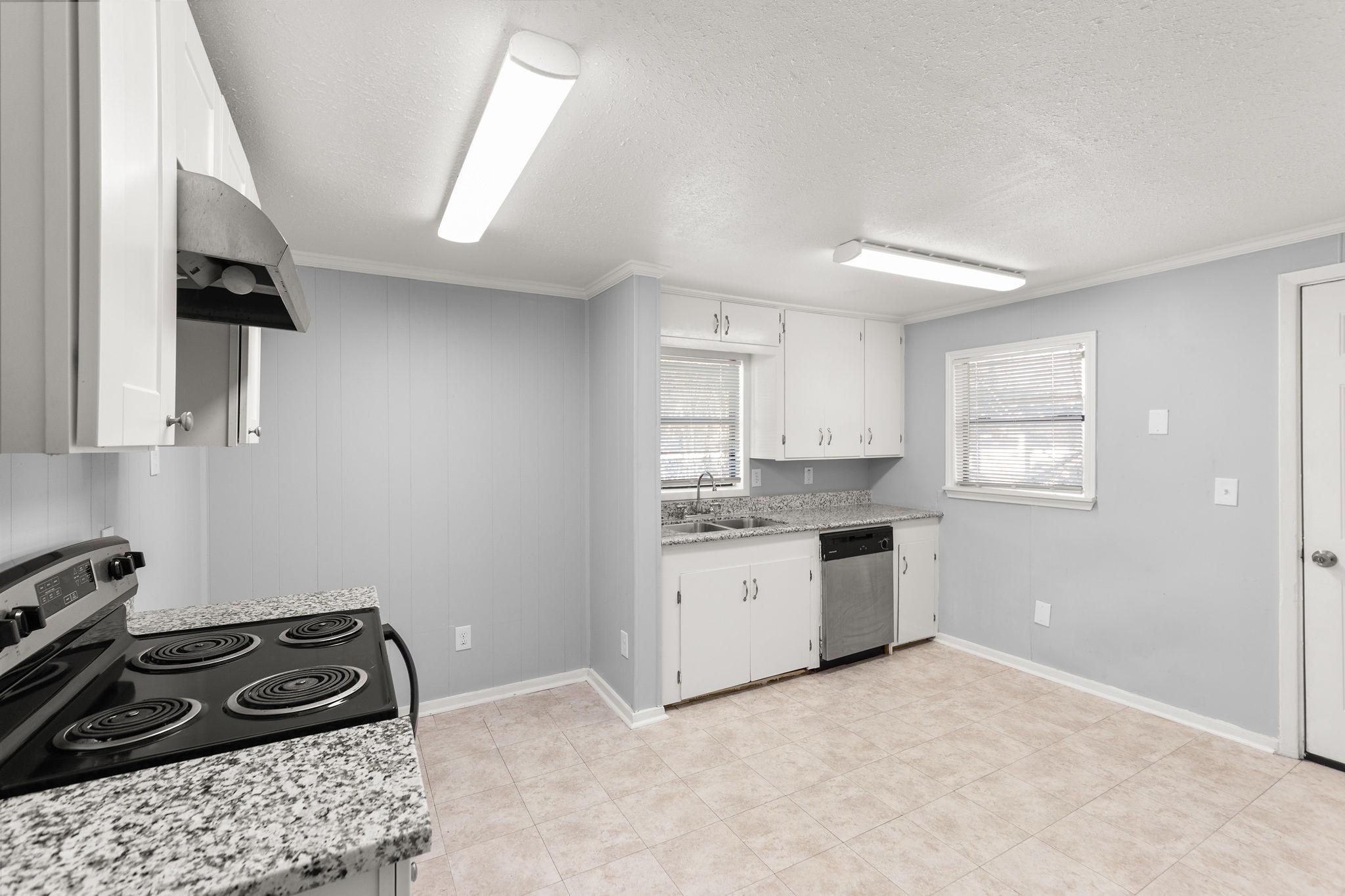 203 South Fig Street Sweeny, TX 77480 - Photo 6 of 20 a kitchen with a stove a sink and a refrigerator