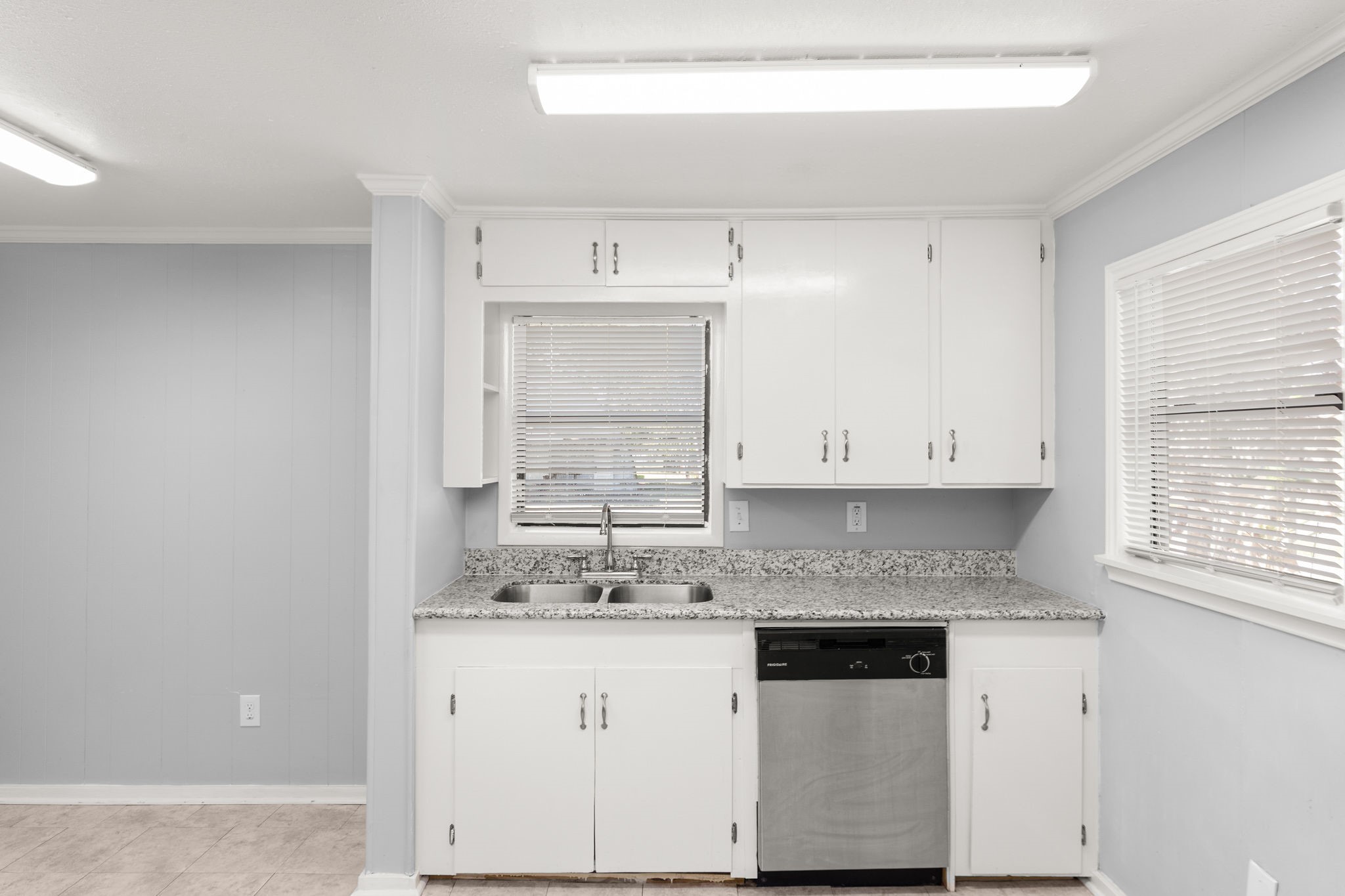 203 South Fig Street Sweeny, TX 77480 - Photo 7 of 20 a kitchen with granite countertop white cabinets and a window